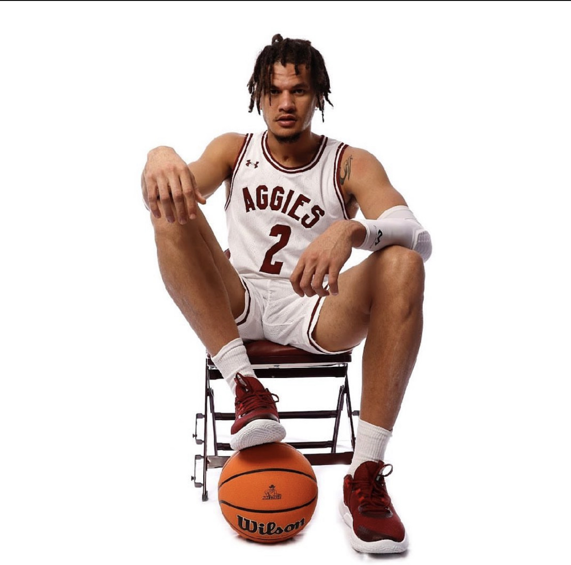 Issa Muhammad, power forward, seated portrait in New Mexico State uniform